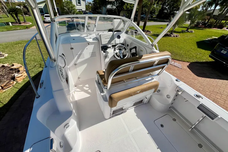 Slide: The Image of 2018 Pro-Line 26 Express boat interior with helm, seating, and modern controls. - 37