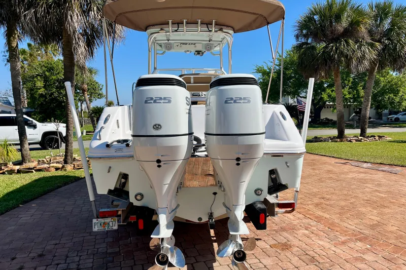 Slide: The Image of 2018 Pro-Line 26 Express boat with twin 225 horsepower engines on a sunny driveway. - 4