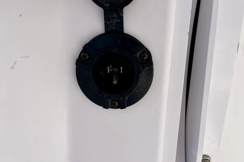 Slide: The Image of Close-up of a 2018 Pro-Line 26 Express boat's electrical socket on a white surface. - 43