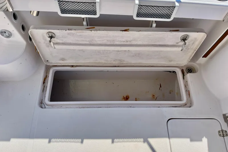 Slide: The Image of Open storage compartment on a 2018 Pro-Line 26 Express boat, showing interior details. - 44