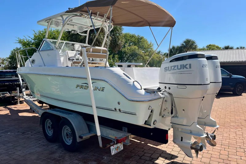 Slide: The Image of 2018 Pro-Line 26 Express boat with twin Suzuki engines on a trailer. - 5