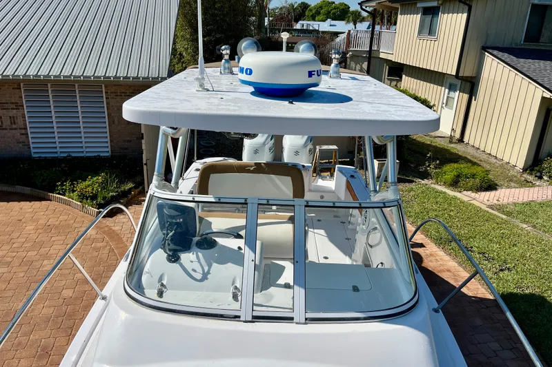 Slide: The Image of 2018 Pro-Line 26 Express boat with radar, parked in a residential driveway. - 51