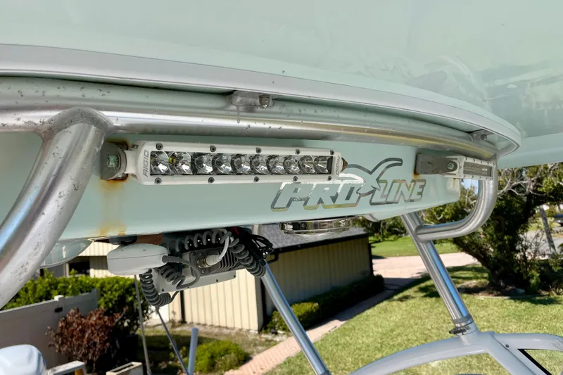 Slide: The Image of 2018 Pro-Line 26 Express boat with mounted LED lights and logo detail. - 56