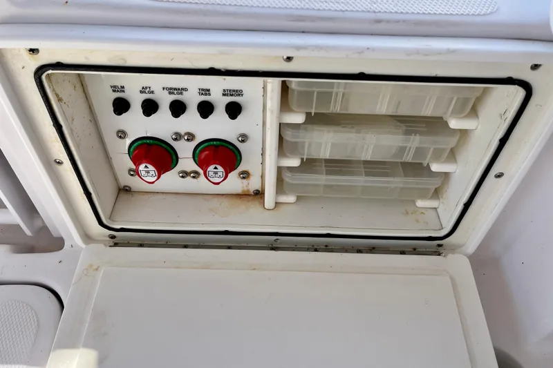 Slide: The Image of Control panel and storage compartments on a 2018 Pro-Line 26 Express boat. - 57