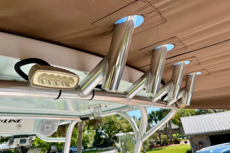 Slide: The Image of 2018 Pro-Line 26 Express boat with rod holders and mounted light under canopy. - 60