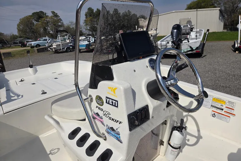 Slide: The Image of 2021 Mako Pro Skiff 15 CC boat console with steering wheel and control panel. - 14