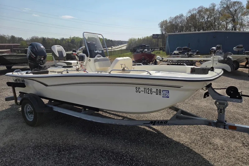 Slide: The Image of 2021 Mako Pro Skiff 15 CC boat on trailer, parked outdoors. - 4