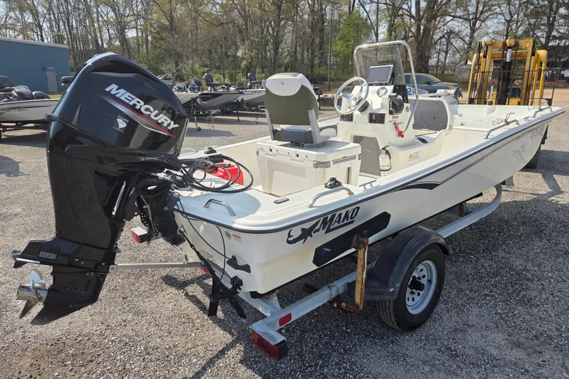 Slide: The Image of 2021 Mako Pro Skiff 15 CC boat with Mercury outboard motor on trailer. - 5