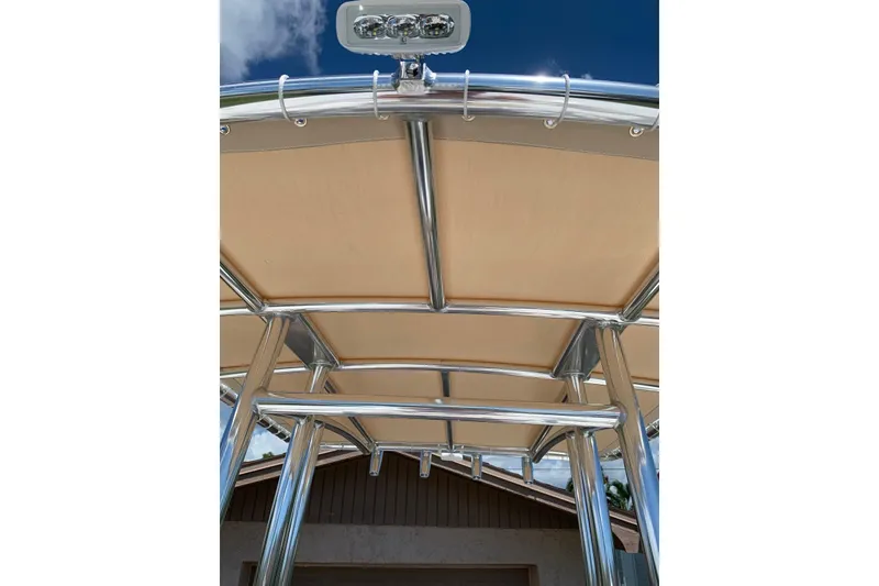 Slide: The Image of Tidewater 1910 Bay Max 2020 boat canopy with stainless steel frame under clear blue sky. - 12