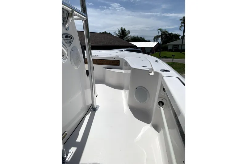 Slide: The Image of 2020 Tidewater 1910 Bay Max boat interior with sleek white design and speaker system. - 6