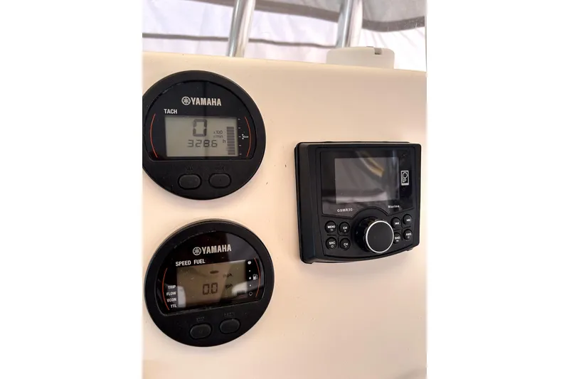 Slide: The Image of Yamaha gauges and marine radio on 2020 Tidewater 1910 Bay Max boat dashboard. - 7