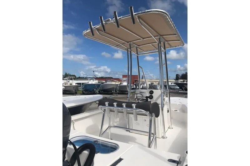 Slide: The Image of 2020 Tidewater 1910 Bay Max boat with T-top and console, docked under blue sky. - 9