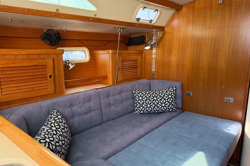 Slide: The Image of Interior of 1995 Catalina 36 MkII sailboat with cozy seating and wooden cabinetry. - 10