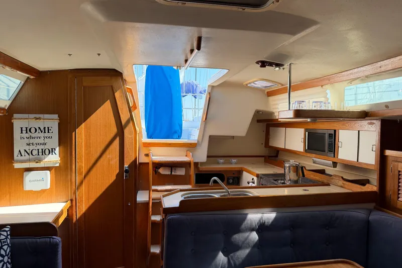 Slide: The Image of Interior of a 1995 Catalina 36 MkII sailboat with kitchen and seating area. - 17