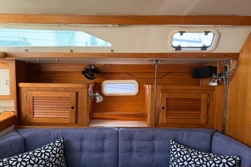 Slide: The Image of Interior of a 1995 Catalina 36 MkII sailboat with wooden cabinets and blue cushions. - 19
