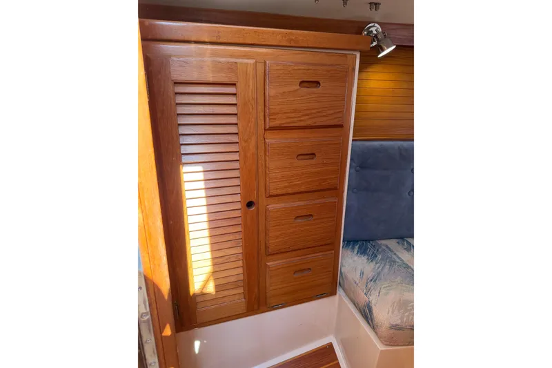 Slide: The Image of Wooden cabinet with louvered door and drawers inside 1995 Catalina 36 MkII sailboat. - 25
