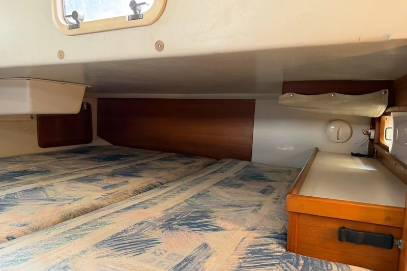 Slide: The Image of Cozy cabin interior of a 1995 Catalina 36 MkII sailboat with patterned bedding. - 26