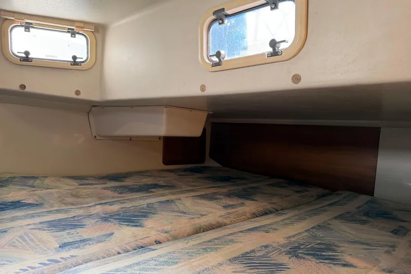 Slide: The Image of Interior cabin of a 1995 Catalina 36 MkII sailboat with patterned bedding. - 27