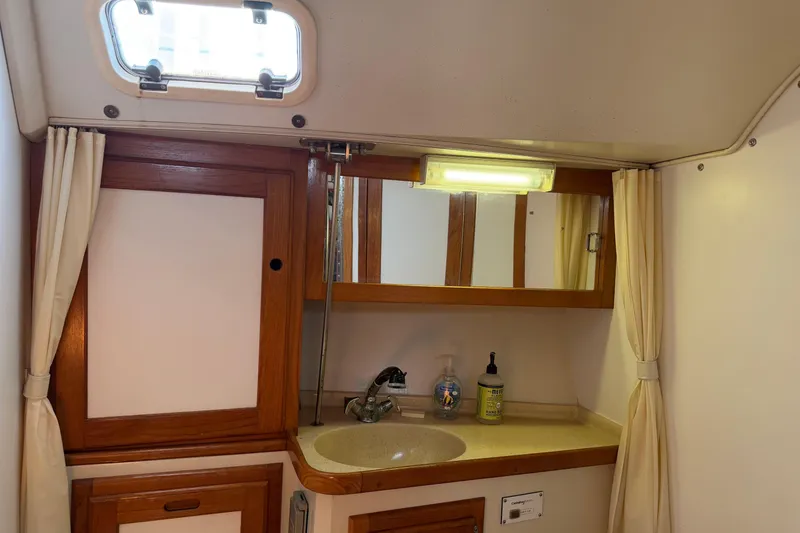 Slide: The Image of Bathroom interior of a 1995 Catalina 36 MkII sailboat with wooden cabinetry. - 28