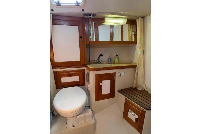 Slide: The Image of Bathroom interior of a 1995 Catalina 36 MkII sailboat with wooden cabinetry. - 29