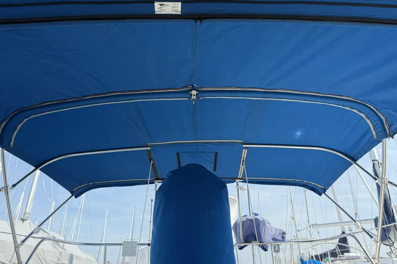 Slide: The Image of Blue bimini top on a 1995 Catalina 36 MkII sailboat, docked at a marina. - 6