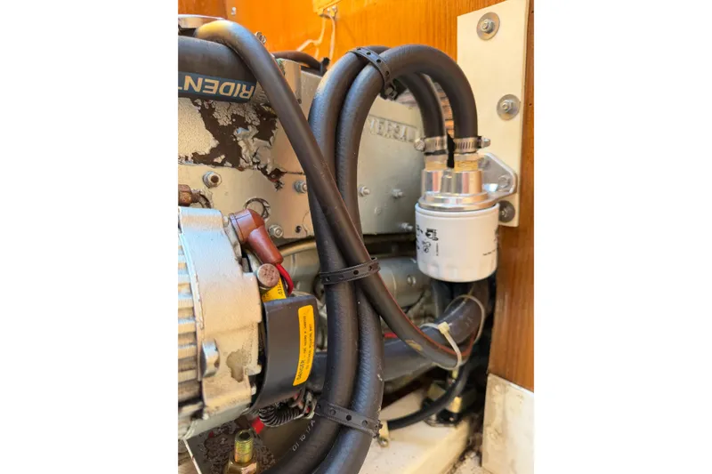 Slide: The Image of Engine compartment of a 1995 Catalina 36 MkII sailboat, showing hoses and filter. - 30