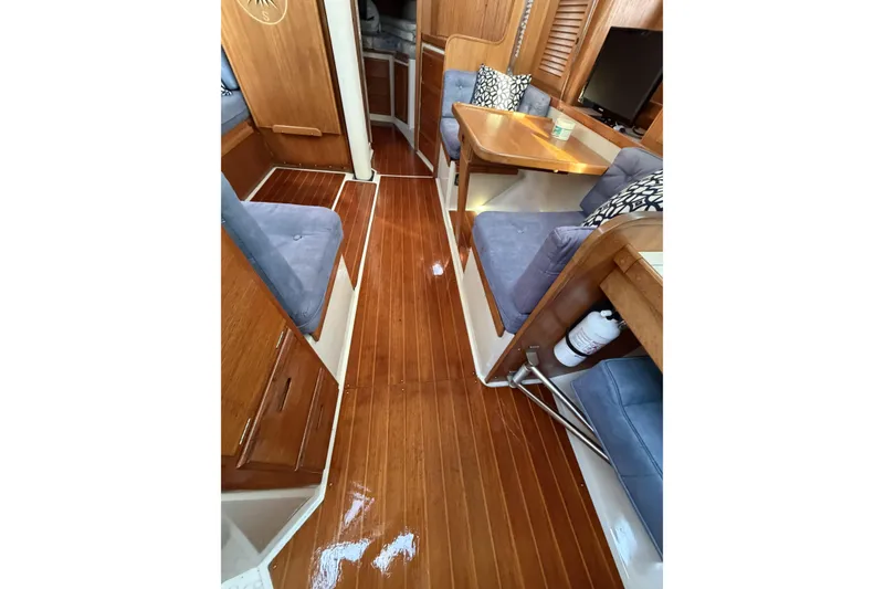 Slide: The Image of Interior of 1995 Catalina 36 MkII sailboat with polished wood flooring and cozy seating. - 7