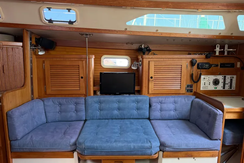 Slide: The Image of Interior of a 1995 Catalina 36 MkII sailboat with blue cushioned seating. - 9