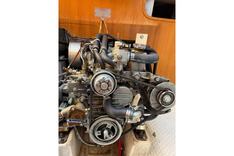 Slide: The Image of Engine of a 1995 Catalina 36 MkII sailboat, showcasing belts and hoses. - 32