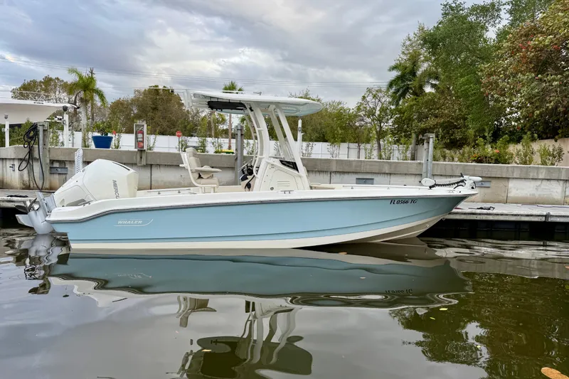 Slide: The Image of 2022 Boston Whaler 220 Dauntless boat docked, featuring sleek design and modern amenities. - 16