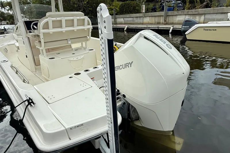 Slide: The Image of 2022 Boston Whaler 220 Dauntless boat with Mercury engine docked at marina. - 18
