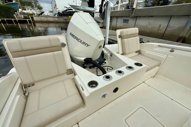 Slide: The Image of 2022 Boston Whaler 220 Dauntless boat with Mercury engine and seating area. - 20