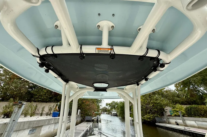 Slide: The Image of 2022 Boston Whaler 220 Dauntless T-top view, showcasing sturdy construction and sleek design. - 24