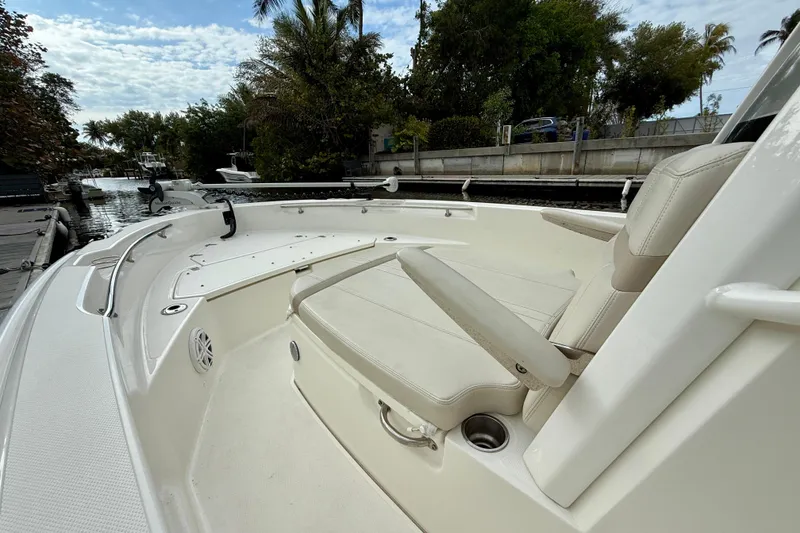 Slide: The Image of 2022 Boston Whaler 220 Dauntless boat interior with seating and waterway view. - 28