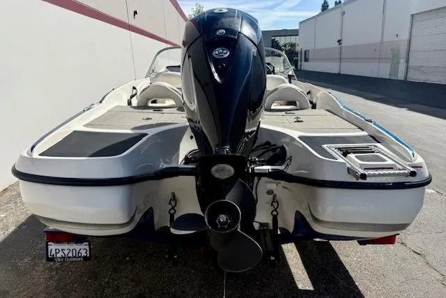 Slide: The Image of 2016 Nitro Z-7 Sport boat with outboard motor, parked outdoors. - 11