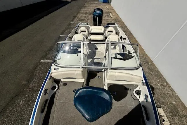Slide: The Image of 2016 Nitro Z-7 Sport boat with seating and windshield, parked on pavement. - 14