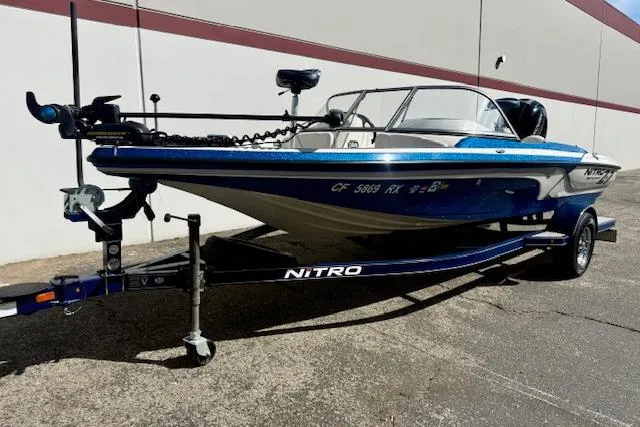 Slide: The Image of 2016 Nitro Z-7 Sport boat on trailer, blue and white design, parked outdoors. - 15