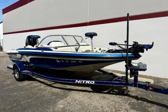 Slide: The Image of 2016 Nitro Z-7 Sport boat on trailer, blue and white design, parked outdoors. - 16