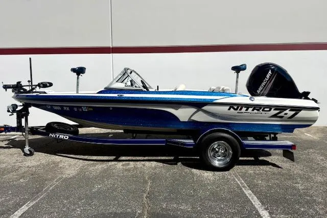 Slide: The Image of 2016 Nitro Z-7 Sport boat with Mercury engine on trailer, parked outdoors. - 17