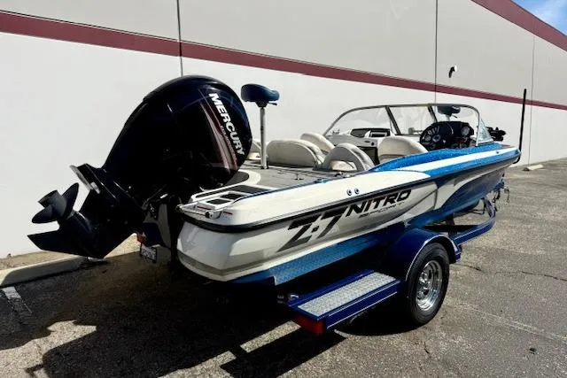Slide: The Image of 2016 Nitro Z-7 Sport boat with Mercury engine on trailer, parked outdoors. - 2