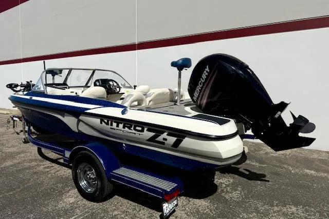 Slide: The Image of 2016 Nitro Z-7 Sport boat with Mercury engine on trailer, parked outdoors. - 21