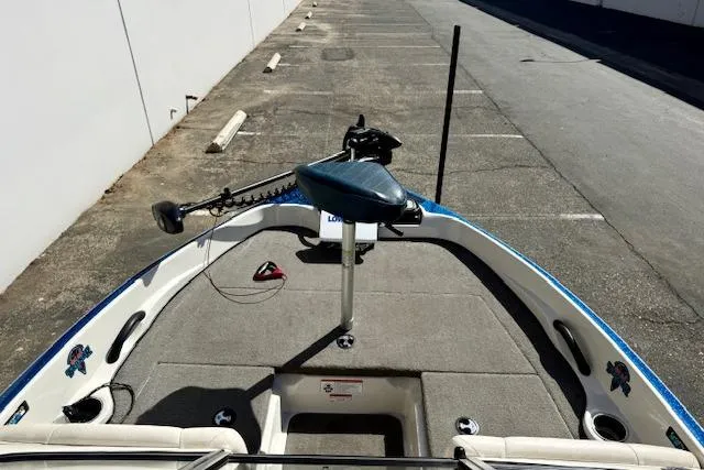 Slide: The Image of 2016 Nitro Z-7 Sport boat deck with trolling motor in a parking area. - 23