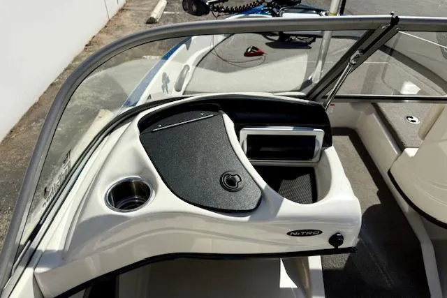 Slide: The Image of 2016 Nitro Z-7 Sport boat dashboard with cup holder and storage compartment. - 24