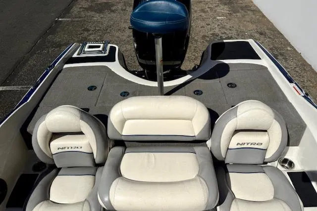 Slide: The Image of 2016 Nitro Z-7 Sport boat interior with white cushioned seats and gray flooring. - 9