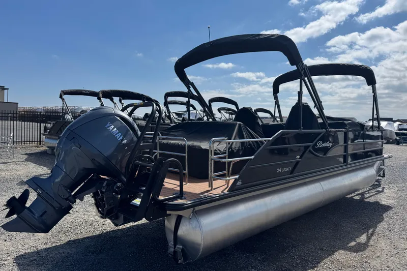 Slide: The Image of 2026 Bentley Pontoons Legacy 243 Swingback with Yamaha engine, parked outdoors under a clear sky. - 10