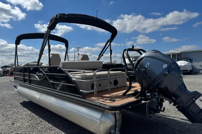 Slide: The Image of 2026 Bentley Pontoons Legacy 243 Swingback with Yamaha outboard motor, parked outdoors. - 12