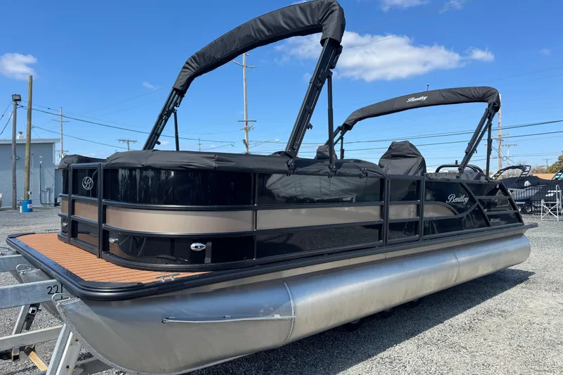 Slide: The Image of 2026 Bentley Pontoons Legacy 243 Swingback pontoon boat with black canopy on display. - 8
