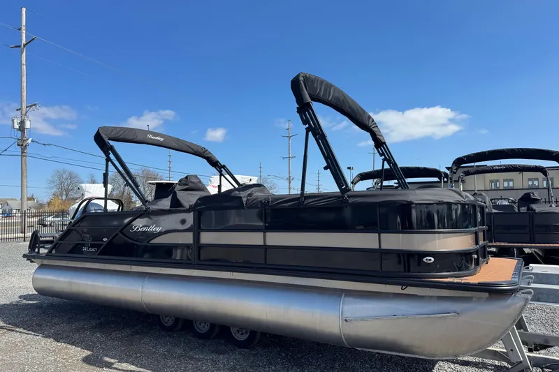 Slide: The Image of 2026 Bentley Pontoons Legacy 243 Swingback pontoon boat under clear blue sky. - 9