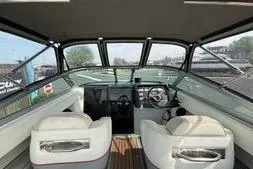 Slide: The Image of Interior view of a 1989 Cobalt Condurre 243 boat with white seating and dashboard. - 4