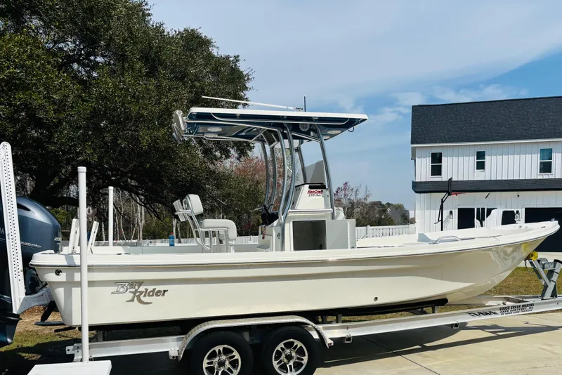 Slide: The Image of 2022 Bay Rider 239 Bay boat on trailer, parked in residential driveway. - 11